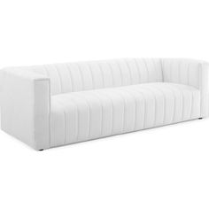 a white couch sitting on top of a white floor