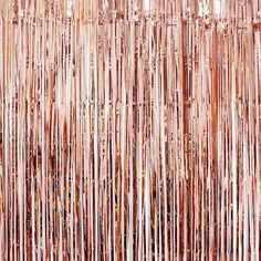 a close up view of the side of a wall covered in pink tinsels