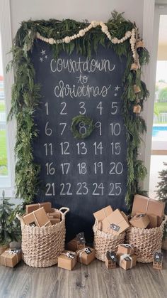 a chalkboard with christmas numbers on it and boxes in front of it, surrounded by presents