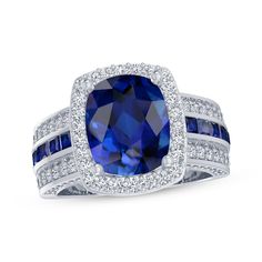 a blue sapphire and diamond ring with two rows of diamonds around the band, set in 18k white gold