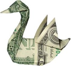 an origami swan made out of one hundred dollar bills is featured in this image