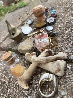 an assortment of items are on the ground next to bottles and other objects that have been left outside