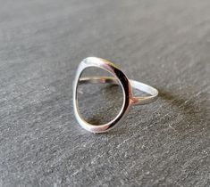 A must-have this season and a real eye-catcher! Beautiful silver ring in a slightly curved oval shape that sits very well on the finger. It is ideal for everyday use and its shape makes it something very special. The ring has a very stable ring rail Material: 925 sterling silver Diameter of the ellipse (oval circle): height: approx. 20 mm, width: approx. 17 mm Ring band width: 3 mm If you have any questions, please send me an email and I'll get back to you, I promise. Sterling Silver Oval Stackable Rings, Modern Oval Midi Rings For Everyday, Handmade Modern Oval Rings, Modern Handmade Oval Rings, Ring Band, I Promise, Get Back, Rings Statement, Oval Shape