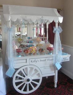 a white cart with candy on it in a room