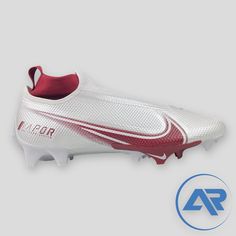 a white and red soccer shoe with an ad for nike on the bottom right side