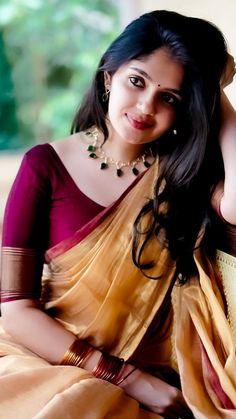 a woman in a sari posing for the camera