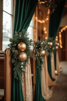 christmas decorations on the stairs in front of a window with green curtains and gold ornaments