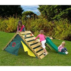 two children playing on a wooden play set