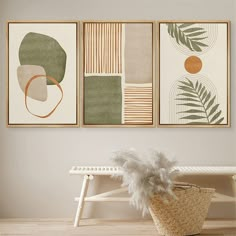 three paintings hang on the wall above a bench in front of a basket with a plant