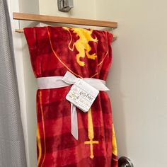 a red and yellow towel hanging on a rack