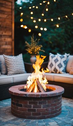 a fire pit sitting in the middle of a patio next to a couch and table