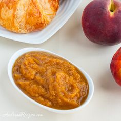 there are two peaches and one piece of bread on the table