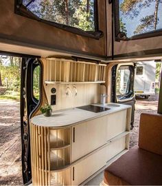 the interior of a camper with an oven and sink