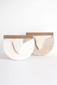 two pieces of wood and concrete are on display