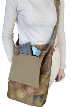 a woman is holding a bag full of items