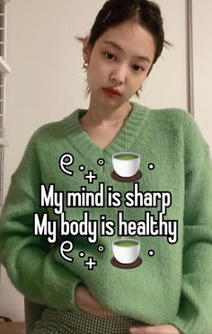 a girl in green sweater holding two cups with the words, my mind is sharp my body is healthy