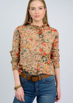 Discover the perfect balance of sophistication and femininity with our Eyelet Floral Snap Shirt. The tan bodice is adorned with a colorful floral print, while ruffled details on the button-up closure and neckline add a touch of elegance. The feminine fit silhouette and front chest pockets complete this luxurious piece. Made by Ivy Jane Anna Beck Jewelry, Tooled Leather Handbags, Chic Leather, Ruffle Collar, Love Is Free, Fall Style, Fall Shopping, 2024 Collection, Fall 2024