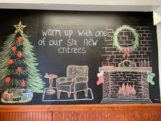 a chalk board with a christmas tree, fireplace and stockings on it that says warm up with one of our six new entrees