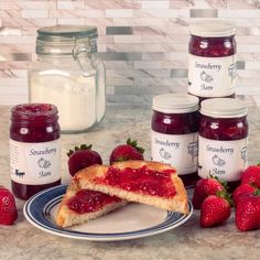 two slices of strawberry jam on a plate with strawberries next to it and jars of jam in the background