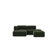 a green couch sitting on top of a white floor next to a black chair and ottoman