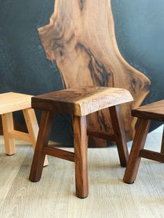 two wooden stools sitting next to each other