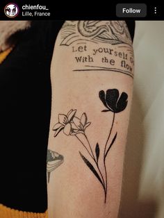 a woman with a tattoo on her arm that says let yourself go with the flow