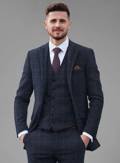 Sustain a stylish and trendy allure with our Italian Atessia Check Tweed Jacket. Meticulously crafted from a sumptuous wool blend, it boasts deep blue hue with a subtle hint of red plaid radiating confidence and refinement. Tailored for the discerning gentleman who prioritizes both style and comfort. Whether you're attending a business meeting or enjoying a weekend getaway, this suit is designed to deliver a polished and refined look without compromising.  Look features a 2 button jacket with no Plaid Semi-formal Winter Suit, Semi-formal Fall Plaid Suit, Fall Semi-formal Plaid Suit, Blue Tweed Blazer With Notch Lapel, Plaid Suits For Business Casual In Winter, Blue Tweed Jacket With Notch Lapel, Timeless Fitted Plaid Outerwear, Fitted Blue Wool Tweed Jacket, Blue Fitted Wool Tweed Jacket