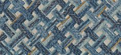 an upholstered blue and white rug with wavy lines on the top, in different colors