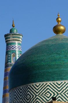 the top of a building with a green and blue dome