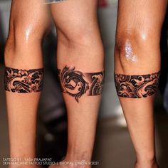 two people with tattoos on their legs and one has a tattoo design on the leg