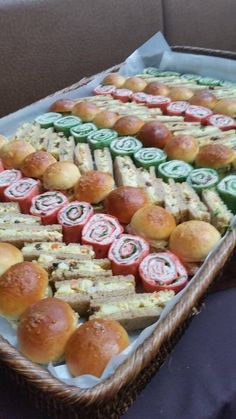 a basket filled with lots of sandwiches on top of a table