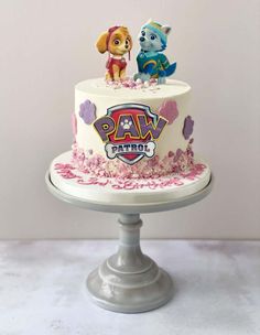 a paw patrol themed cake with two dogs on top