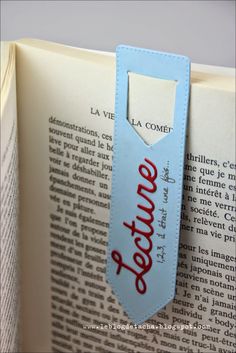 an open book with a tag on it that says jereme in red and blue