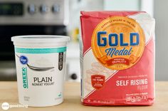 a cup of plain yogurt next to a bag of plain yogurt