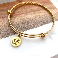 Welcome to buttrescharms! We are newly opened shop and offering the best price for our unique custom bracelets! ❤️This listing is for one OM Bangle bracelet shown above. All the charms and bangle are made of stainless steel. ❤️ You can keep it simple, or you can add birthstone, Initial letter--leave a message about the Size: Small, Medium, Large ❤️We hand pick the best quality charms and beads from around the world to make this bracelet timeless. ❤️ How long until I get my order? We normally shi Spiritual Stackable Charm Bracelet Gift, Spiritual Hypoallergenic Bangle Jewelry, Adjustable Charms Bangle For Gift, Customizable Adjustable Spiritual Jewelry, Gold Bangle With Birthstone For Gift, Gold Bangle With Birthstone As Gift, Gold Spiritual Bracelet For Birthday Gift, Personalized Spiritual Bangle Bracelet, Spiritual Round Stainless Steel Bracelets