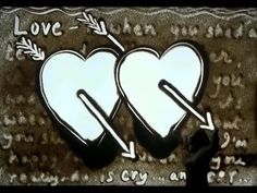 two white hearts with arrows drawn on them and the words love written in black ink