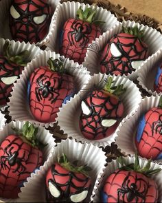 chocolate covered strawberries with spider - man faces and green sprouts on them