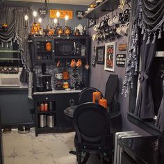 a room filled with lots of black furniture and decorations