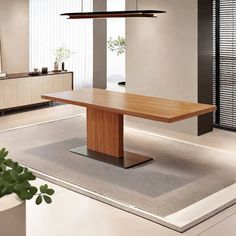 a large wooden table sitting on top of a white floor next to a planter