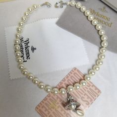 Vivienne Westwood Pearl Drop Choker In Silver Brand New, Never Worn Comes With Gift Box, Gift Bag, And Dust Bag,Brand Cards,As You Can See From The Photos. The Gold -Tone One-Row Pearl Drop Choker Features A String Of Glass-Based Pearls Coated With An Iridescent Material To Simulate Natural Pearls. Pearl Drop Crystal-Encrusted Orb Motif Chain Length: 37cm Welcome To Reasonable Offers! Vivienne Westwood Melissa Shoes, Vivienne Westwood Pearl Necklace, Iridescent Material, Vivienne Westwood Melissa, Vivienne Westwood Bracelet, Vivienne Westwood Earrings, Saturn Necklace, Melissa Shoes, Pearl Choker Necklace