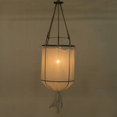 a light hanging from the ceiling in a room