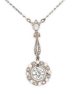 A lovely 1.00-carat bezel set diamond is surrounded by diamonds and pearls in this enchanting Edwardian pendant necklace. Delicate details and milgrain work provide additional interest and charm. Set in platinum and gold. Early 20th century Pendant: 1 2/5" length Vintage Pendant Necklace With Brilliant Cut, Classic Platinum Necklace With Rose Cut Diamonds, Elegant Necklace With Rose Cut Diamonds In Platinum, Elegant Platinum Necklace With Rose Cut Diamonds, Platinum Rose Cut Diamond Necklace For Wedding, Wedding Rose Cut Diamond Platinum Necklace, Wedding Platinum Necklace With Rose Cut Diamonds, Platinum Pendant Necklace With Rose Cut Diamonds, Heirloom Silver Necklace With Pearl Pendant