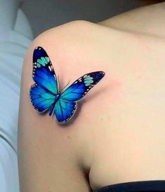 a blue butterfly on the back of a woman's shoulder