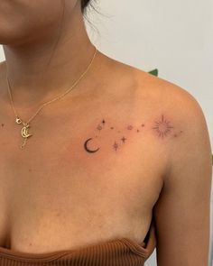 a woman's chest with stars and moon tattoos on her left side, while the rest of her arm is visible