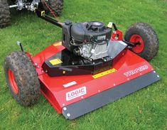 a red lawn mower sitting on top of green grass