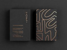 two business cards on top of each other with an abstract design in gold and black