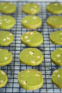 green cookies are cooling on a wire rack