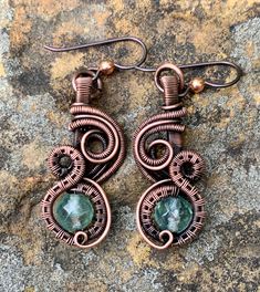 Handwoven Copper and Coils Swirl around light blue/green Faceted Fluroite in these Hypoallergenic Earrings. Green Wrap Drop Earrings With Ear Wire, Green Drop Wrap Earrings With Ear Wire, Green Spiral Earrings As Gift, Artisan Copper Wire Wrapped Earrings, Elegant Copper Wire Wrap Earrings, Green Copper Wire Earrings Gift, Green Wire Wrapped Round Earrings, Unique Green Wire Wrapped Earrings, Spiral Copper Wire Jewelry With Ear Wire