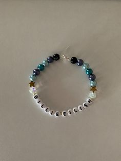 a beaded bracelet with the word believe written on it