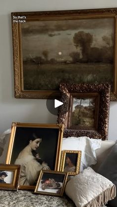 a bed with pictures and paintings on the wall